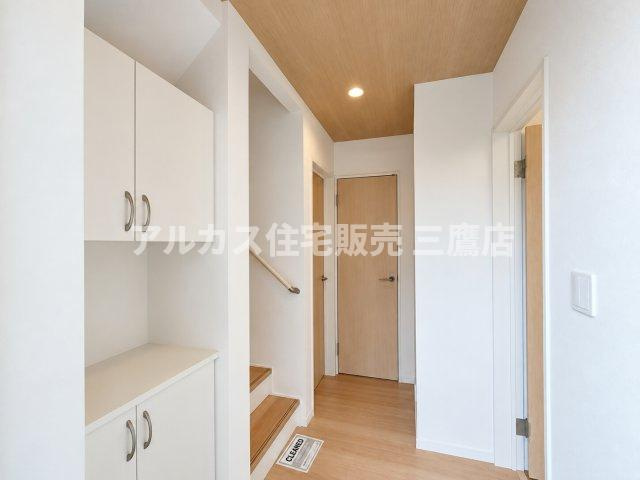 【内覧動画公開中！】三鷹市上連雀7丁目 中央線 三鷹駅 新築戸建の玄関|ナチュラルトーンの木目天井と明るいフローリングが温かみを感じさせる、開放的な玄関ホールです。大容量のセパレート型シューズボックスを備え、カウンター部分も自由に使えます。