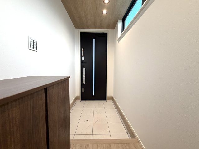 越谷市大竹２号棟　新築戸建の玄関|開放感のある吹抜け設計の玄関スペース。上部からの自然光が玄関全体を明るく照らします。
