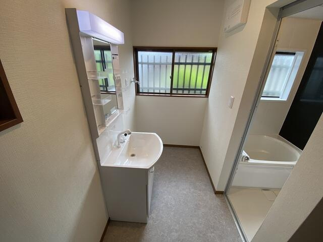 富士市今泉４丁目の中古一戸建の洗面所|収納ラックや洗濯かごを置きやすい広々とした脱衣所。家族分のタオルや着替えも整理しやすい空間です。