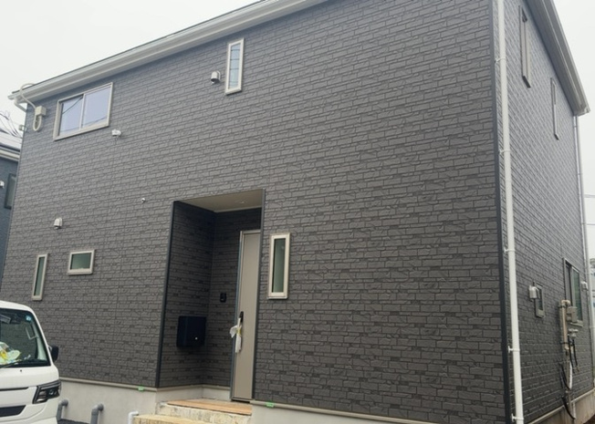 【外観】 | 宮下町新築戸建 | 八王子市宮下町の閑静な住宅街に佇む、建物面積98.81㎡の木造2階建て新築住宅。135.03㎡の広い敷地と落ち着いたデザインの外壁が特徴的で、加住小学校まで約283mと子育てにも適したロケーションです