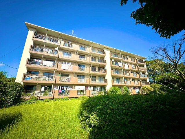 北磯子住宅5号棟の外観|手入れの行き届いた植栽やきれいに保たれたマンション周りなどから管理がしっかりとなされていることがうかがえます。小学校が徒歩10分、中学校が徒歩5分にある為学齢期の子供を持つファミリーにうれしい立地です