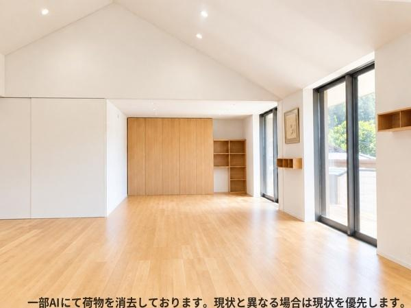 三重町　戸建ての居間・リビング|大きな窓から光が差し込むリビングです。天井が高く開放感のある空間が広がります。シンプルな内装と木目のフローリングが特徴です。収納スペースも豊富で整理しやすいです。壁面の棚もアクセントになっています。