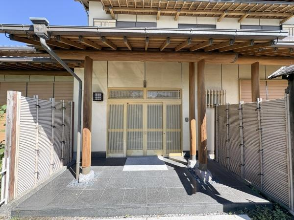 王ノ瀬1丁目　戸建ての玄関|木の温もりを感じるデザインが特徴の玄関です。広めのアプローチ部分がすっきりとした印象を与えます。重厚な門構えと格子戸が和の雰囲気を引き立てています。