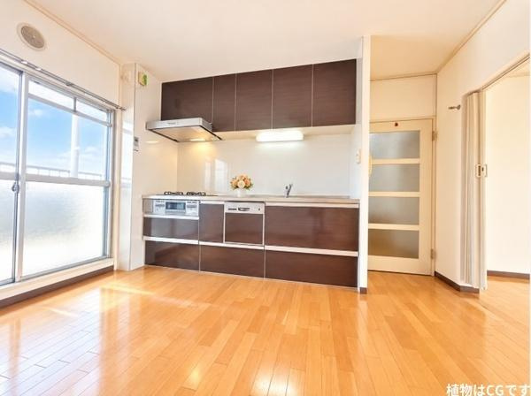 藤阪パークハイツ　１号棟　中古 マンションのキッチン|落ち着いたダークブラウンのキッチンが空間を上品に演出。大きな窓から差し込む自然光が明るく開放的な雰囲気を生み出し、毎日のお料理も家族との食事も楽しみになる住まいです。