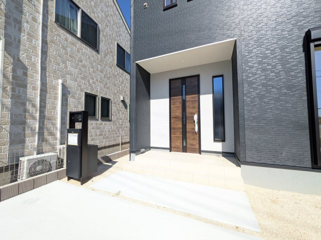 那珂市菅谷　19期　新築戸建て　2号棟の玄関|お洒落な玄関ドアと洗練された外壁デザイン。家の顔にふさわしい上質な佇まいで、ご家族やお客様を迎えます。