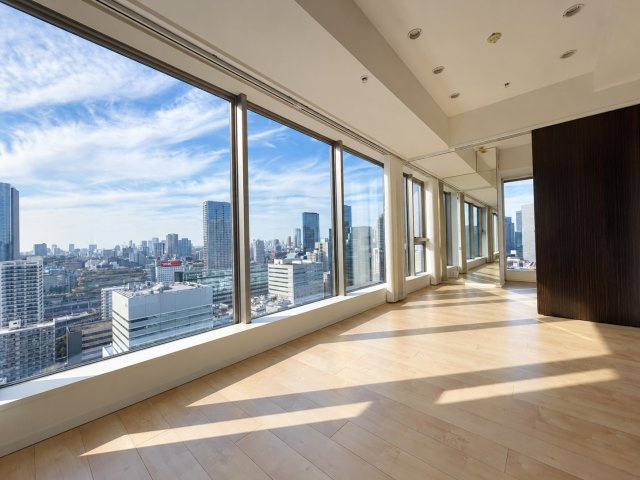 東京ベイシティタワーの居間・リビング|壁一面に広がる大きな窓が印象的なリビングダイニング。25階の高層階から都心の街並みを一望できる、開放感あふれる住空間です。