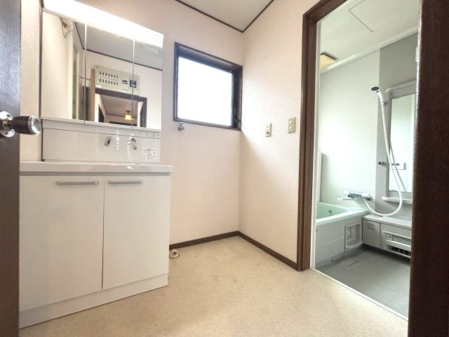 入間市下藤沢 中古戸建の独立洗面台|窓付きの洗面脱衣室。洗面化粧台のほか、洗濯機置場も確保されており、毎日の身支度や家事を快適に行えます。