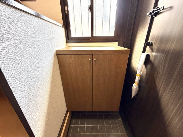 越谷市神明町２丁目　中古戸建の玄関|扉裏にスリッパラックや小物入れを備えた賢い収納。必要なものをサッと取り出せて便利です。