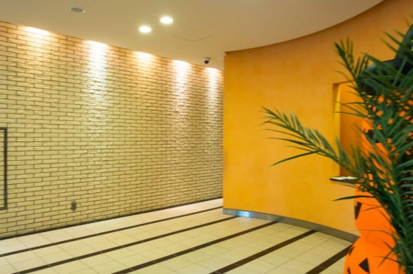 【エントランス】 | 【エントランスホール】印象的な明るいオレンジ色の壁が、オーナーやゲストをやさしくお出迎えします。