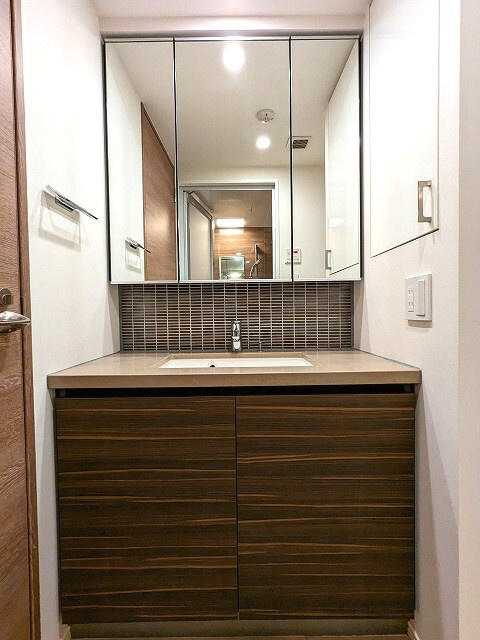ザ・パークハビオ根岸三丁目の設備|三面鏡付トイレと独立した洗面台です。
洗濯機置場のお手入れ楽な足高の防水パンに排水口を手前中央に配置
