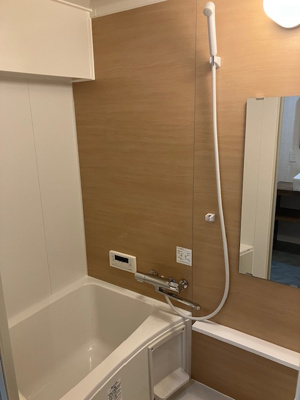 【浴室】 | 進和江坂アーバンライフ | 木目調のアクセントパネルで温かみがあり、ホッと癒されるバスルーム！湯船に浸かって、一日の疲れを癒していただけます。