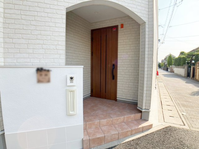 森南町2丁目 中古戸建の玄関|アーチのを潜って入る特別感のある玄関は、木製の扉とタイルの色合いが素敵です