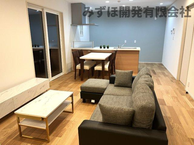 村山市楯岡二日町の居間・リビング|使い勝手の良い長方形のLDK　キッチンの腰壁とフローリングの色合いを合わせたのもポイントです◎和室の間仕切りを閉めても明るく、圧迫感を感じません！