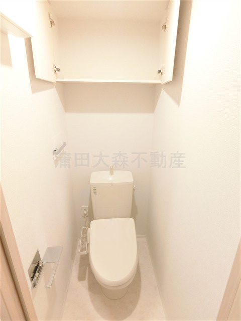 ドゥーエ梅屋敷のトイレ|吊戸棚と温水洗浄便座付きのトイレ　