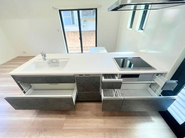 AG-HOUSE　光吉　A棟のキッチン|引き出し収納が充実したシステムキッチンは、調理器具や食器、ストック品まですっきり整理可能。動線を邪魔しないスライド式で、出し入れもスムーズ。使いやすさと見た目の美しさを両立しています！