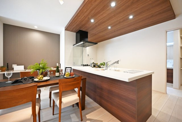 尼崎市東園田町7丁目新築一戸建て│2LDK+2S│並列駐車2台可のキッチン|キッチン上部にはダウンライトを配置し折り下げ天井のアクセントが美しいナチュラルモダンのキッチンに仕上がりました。スタディーコーナーを設けており、椅子を3つ置いてちょうどいい配置となっております。
