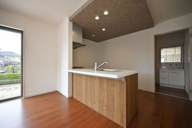 テラシエ水明台2丁目新築一戸建て│5LDK+駐車並列2台可のキッチン|キッチンは折り下げ天井やダウンライトなどデザイン性の高い設計に終始しています。