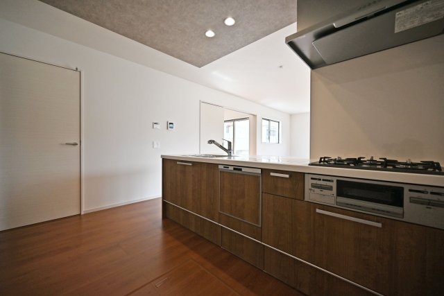 テラシエ水明台2丁目新築一戸建て│5LDK+駐車並列2台可のキッチン|1階キッチン奥側から撮影した写真です。浄水器一体型水栓、フラット整流板、食器洗い乾燥機などの充実した設備内容です。