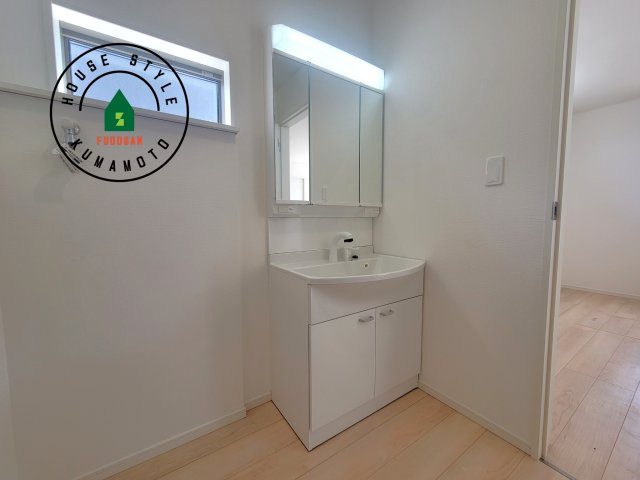 宇土市岩古曽町第2-7棟（4号棟）の独立洗面台|毎日使うものだから清潔な空間を保ちたい水回り。洗面にはそんな願いを解消させてくれる収納アイデアが満載です。三面鏡の裏側にはキャビネットが現れ小物から背の高い物まで収納できます。