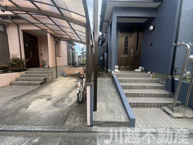 タクトホーム施工のフルリノベ中古戸建のエントランス|道路から奥まった位置の玄関のため傾斜が緩いアプローチになっています