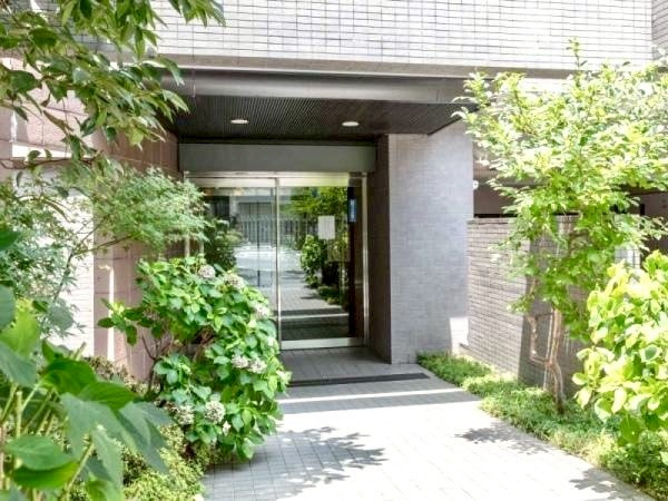 横浜高砂パークハウスのエントランス|石材やタイルをあしらった高級感のあるファサード、丁寧に手入れされた植栽も魅力のひとつです。