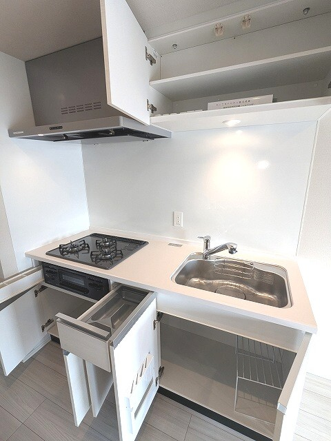 Opus Residence上野元浅草の設備|グリル付ガス3口システムキッチン、瀟洒でお手入れ楽なガラストップコンロ、広々のシンク、ハンドシャワー、豊富な収納