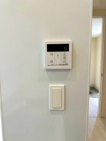 ブルーミングガーデン西原町小那覇・２号棟の防犯設備|ガス給湯器リモコン／シンプルなデザインでインテリアに馴染む電気スイッチ