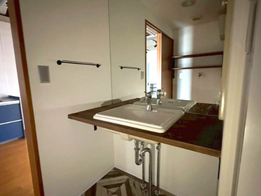 サーパス久保田の洗面所|室内洗濯機置場を完備し、2019年のリノベーションで洗面化粧台も新調されました。大型の鏡を備えた洗面台は、朝の身支度をスムーズにします。脱衣スペースも確保されており、スムーズな動線を実現。