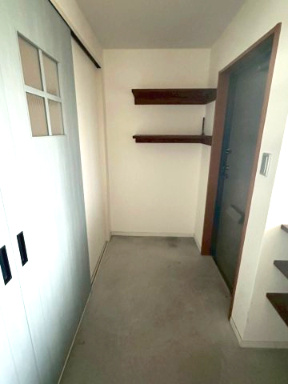 サーパス久保田の玄関|広々としたコンクリート仕上げの土間玄関。ベビーカーやアウトドア用品も汚れを気にせずそのまま置けるので便利。趣味の自転車を置いたりDIYスペースとして活用したりと、多様な使い方ができる魅力的な空間です。