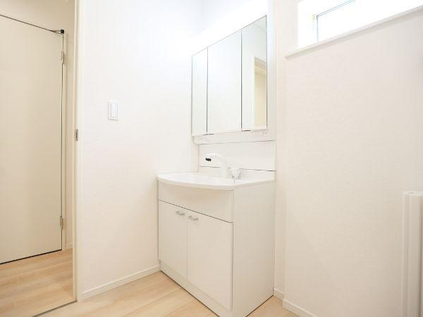 挾間町下市第1-3号棟の独立洗面台|シンプルなデザインの洗面台が特徴です。収納スペースがしっかりと確保されています。明るい室内が清潔感を感じさせます。鏡面収納が便利に使えます。隣接する窓から採光が取れ気持ちよくご利用いただけます。