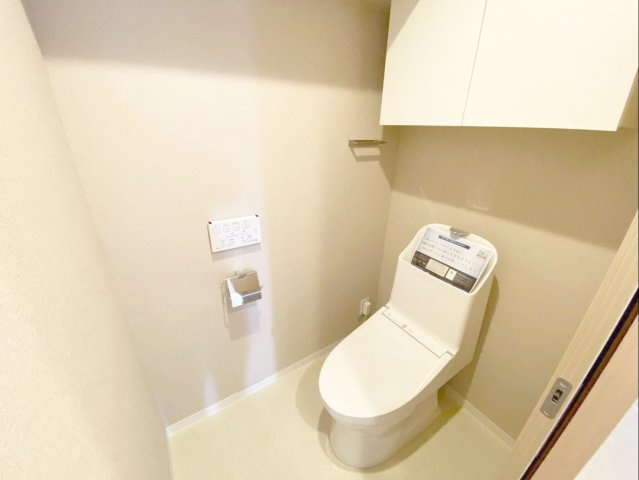 三愛シティライフ箱崎12のトイレ|温水洗浄便座付きの清潔なトイレです！トイレの小物がスッキリ整理できる吊戸棚があります！