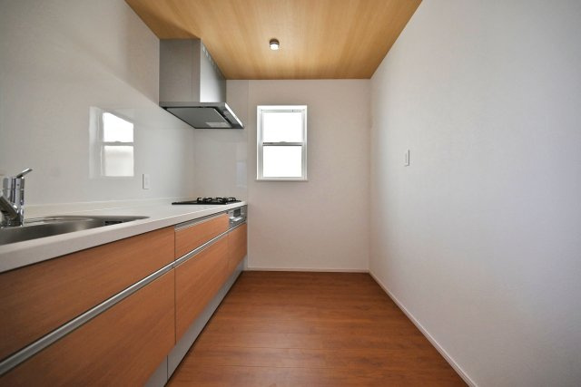 ファーストタウン西難波町2丁目新築一戸建て│1LDK+2S+駐車1台可のキッチン|背面に冷蔵庫やカップボードを設置しても、複数人でキッチンに立っても窮屈感を感じることがない幅が確保されています。キッチン上部にはダウンライトを採用し、作業性を確保しています。