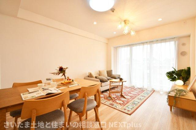 コスモ浦和ガーデンフォルムの居間・リビング|LDK13.5帖：新規リフォームで綺麗に生まれ変わりました！カウンターキッチンの前にはダイニングテーブル、奥にソファーやテレビを置く事でダイニング空間とリビング空間を分ける事ができメリハリがつきます！