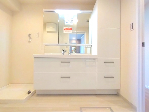 ネオグランデ鹿山 北館の独立洗面台|毎日の身だしなみを快適にする機能的な洗面化粧台です。明るい照明と清潔感のあるデザインで、朝の準備から一日の終りのリフレッシュタイムまで心地よくお使いいただけます。