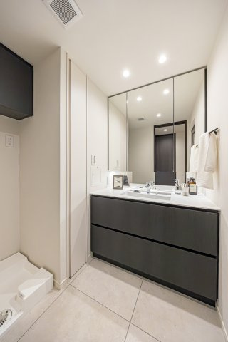 神楽坂パークハウスの独立洗面台|洗面化粧台は、キッチンと同じく田中工藝製で上品さが宿ります。キッチンと統一感のあるデザインで、入浴後の豊かな時間を演出し、心からくつろげるプライベート空間です