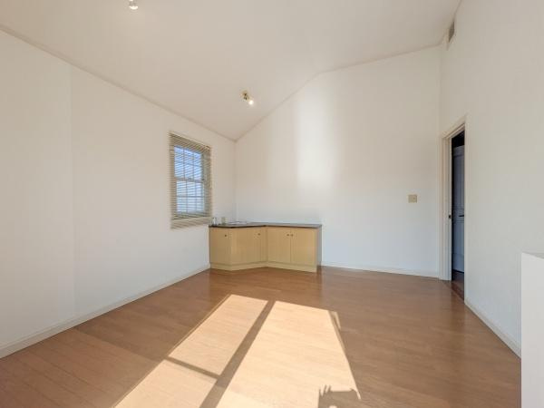 王ノ瀬一丁目　中古の洋室|明るい光が差し込む洋室です。壁と天井が白くすっきりとした印象です。窓際にカウンターが設置されています。シンプルな内装で自由度があります。床は木目調で落ち着いた雰囲気です。