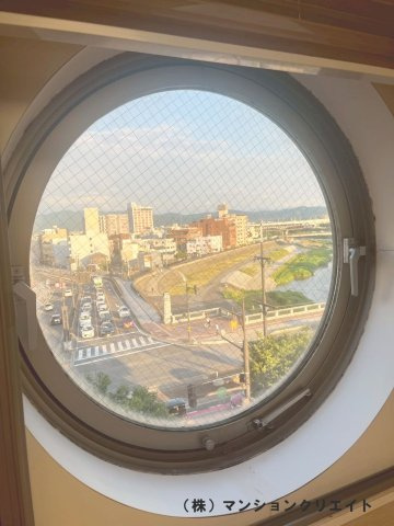 幸橋グランデCHAの展望|洋室5.4帖の丸窓　東側の足羽川の景色が抜けて見えます
　