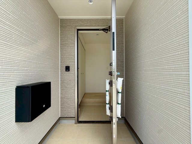 クレイドルガーデン糸満市宇江城 第2・4号棟の玄関|屋根付きで置配スペースも確保できる玄関ポーチ／人感センサー＆防犯カメラ＆TVモニター付きインターフォン設置