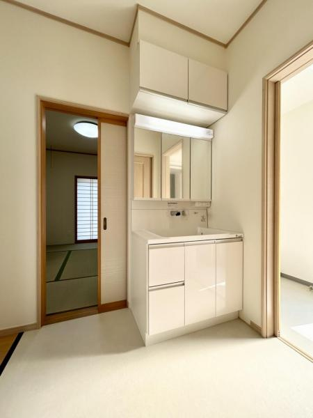 丸亀市中津町　リフォーム戸建の独立洗面台|洗面化粧台は新品に交換しました。一部壁のクロス張替、床をクッションフロアに張り替えました。三面鏡の収納棚が付いたタイプになります。