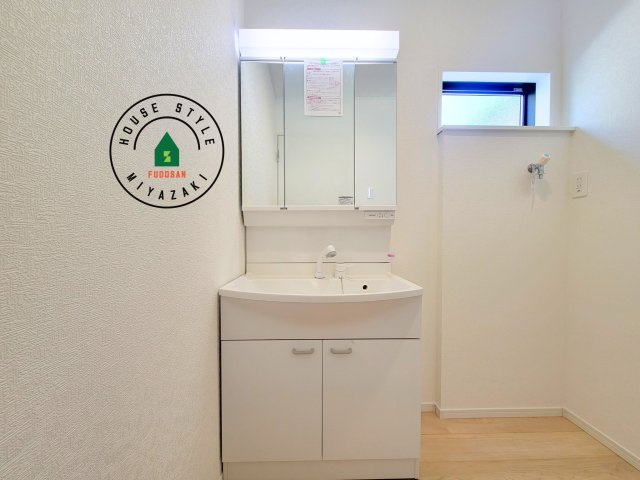 宮崎市島之内第12-2棟（2号棟）の独立洗面台|毎日使うものだから清潔な空間を保ちたい水回り。洗面にはそんな願いを解消させてくれる収納アイデアが満載です。三面鏡の裏側にはキャビネットが現れ小物から背の高い物まで収納できます。