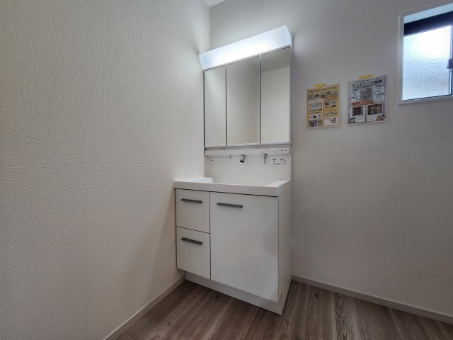 春日市弥生7丁目第1-3棟(3号棟)の独立洗面台|毎日使うものだから清潔な空間を保ちたい水回り。洗面にはそんな願いを解消させてくれる収納アイデアが満載です。三面鏡の裏側にはキャビネットが現れ小物から背の高い物まで収納できます。