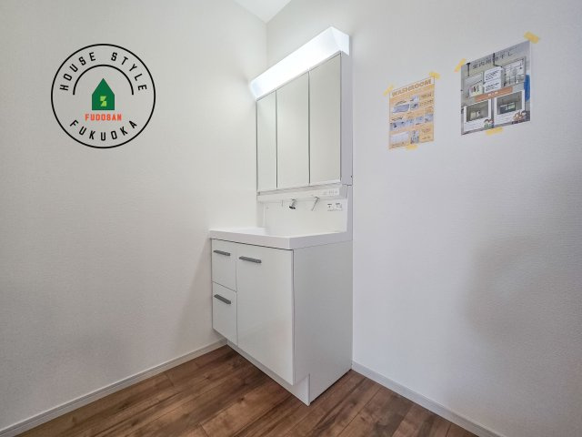 太宰府市青山2丁目第3-2棟(2号棟)の独立洗面台|毎日使うものだから清潔な空間を保ちたい水回り。洗面にはそんな願いを解消させてくれる収納アイデアが満載です。三面鏡の裏側にはキャビネットが現れ小物から背の高い物まで収納できます。