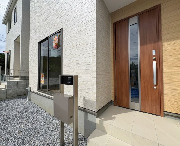 リーブルガーデン南城市佐敷新里・3号棟の玄関|屋根付きで置き配スペースも確保できる玄関ポーチ／人感センサー＆TVモニター付きインターフォン