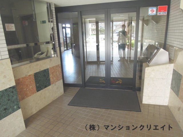 信開ガーデンコート文京のエントランス|マンションエントランス。管理人室があり、オートロック式のドア