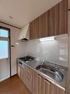 【キッチン】 | 小泉テラスB | 白を基調としたシステムキッチンです！換気のできる窓付きでお料理の匂いもこもりません！横には勝手口があり、外へ出られます♪便利な床下収納つき☆