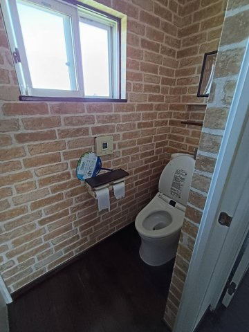 西条市周布892-5　中古住宅のトイレ|1階と2階の両方に完備され、寝室からの移動もスムーズ。小窓から差し込む優しい光が空間を明るく演出し、常にフレッシュな空気を保てる。掃除のしやすい床材と、落ち着く色使いで構成された清潔な空間。