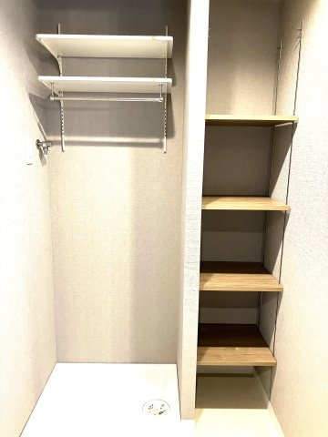 室内洗濯機置き場の横には収納棚もございます。