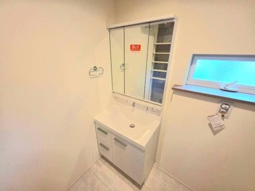 小川町１丁目新築住宅の洗面所|シンプルなデザインの洗面台でお手入れしやすい空間です。ミラーキャビネット付きで収納力も十分あります。窓から自然光が入り明るい雰囲気が感じられます。清潔感のある色合いが特徴的です。