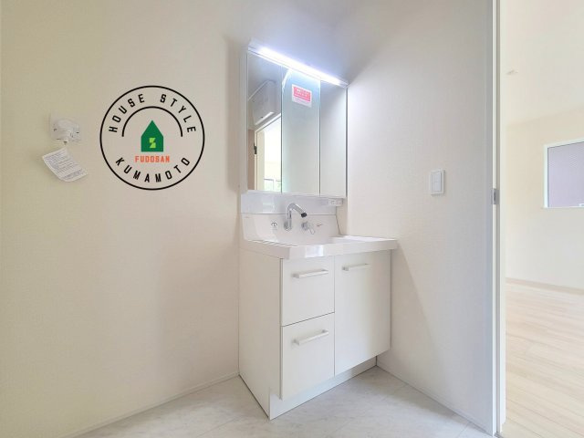 熊本市中央区壷川1丁目第1-2棟（2号棟）の内観：施工例|毎日使うものだから清潔な空間を保ちたい水回り。洗面にはそんな願いを解消させてくれる収納アイデアが満載です。三面鏡の裏側にはキャビネットが現れ小物から背の高い物まで収納できます。