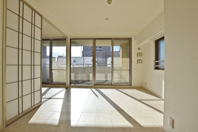 ネバーランド江坂垂水町の居間・リビング|バルコニーからの明るい光が差し込む空間です。